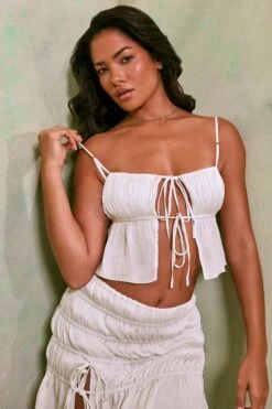 Shirred Tie Up Front Crop Top In White 13 Shirred Tie Up Front Crop Top In White -Sway Line Zone 7195 7206 6 White Tie Up Front Crop Top Crinkle Tie Up Asymmetrical Shirring Mini Skirt